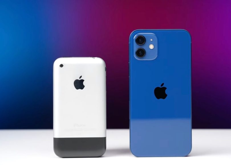 White original iPhone and blue iPhone 12 standing upright on a white table in front of a blue-to-magenta gradient background